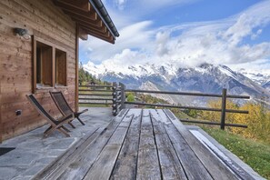 A wooden cabin with a deck overlooking a mountainous landscape. - Beautiful Luxury Chalet Veyon With Incredible Views (Riddes)