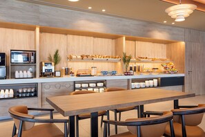 A modern kitchen with a wooden countertop, a microwave, and a coffee station. - B&B Hotel Vila Do Conde (Vila do Conde)