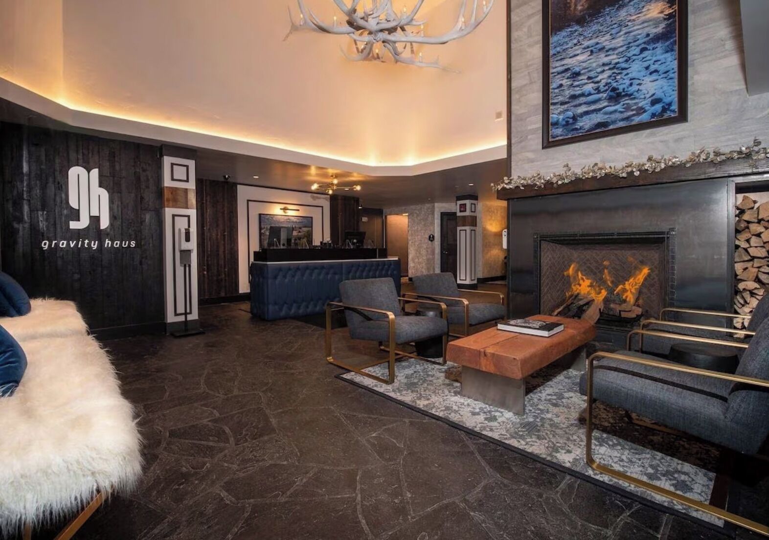 A modern lobby with a fireplace, seating area, and a reception desk.