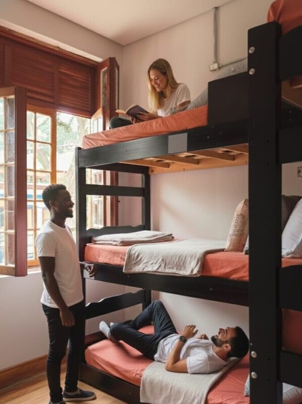 A bunk bed room with a person standing and another lying on the lower bunk. - Hobi Hostel Boutique - Bela Vista / Av. Paulista (São Paulo)