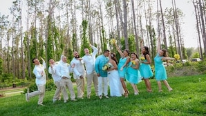 A group of people outdoors with trees in the background.