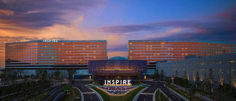 A modern building complex with the name 'INSPIRE' prominently displayed.