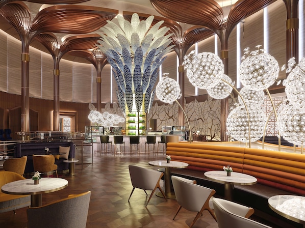 A modern interior with a central decorative column, seating areas, and a bar.