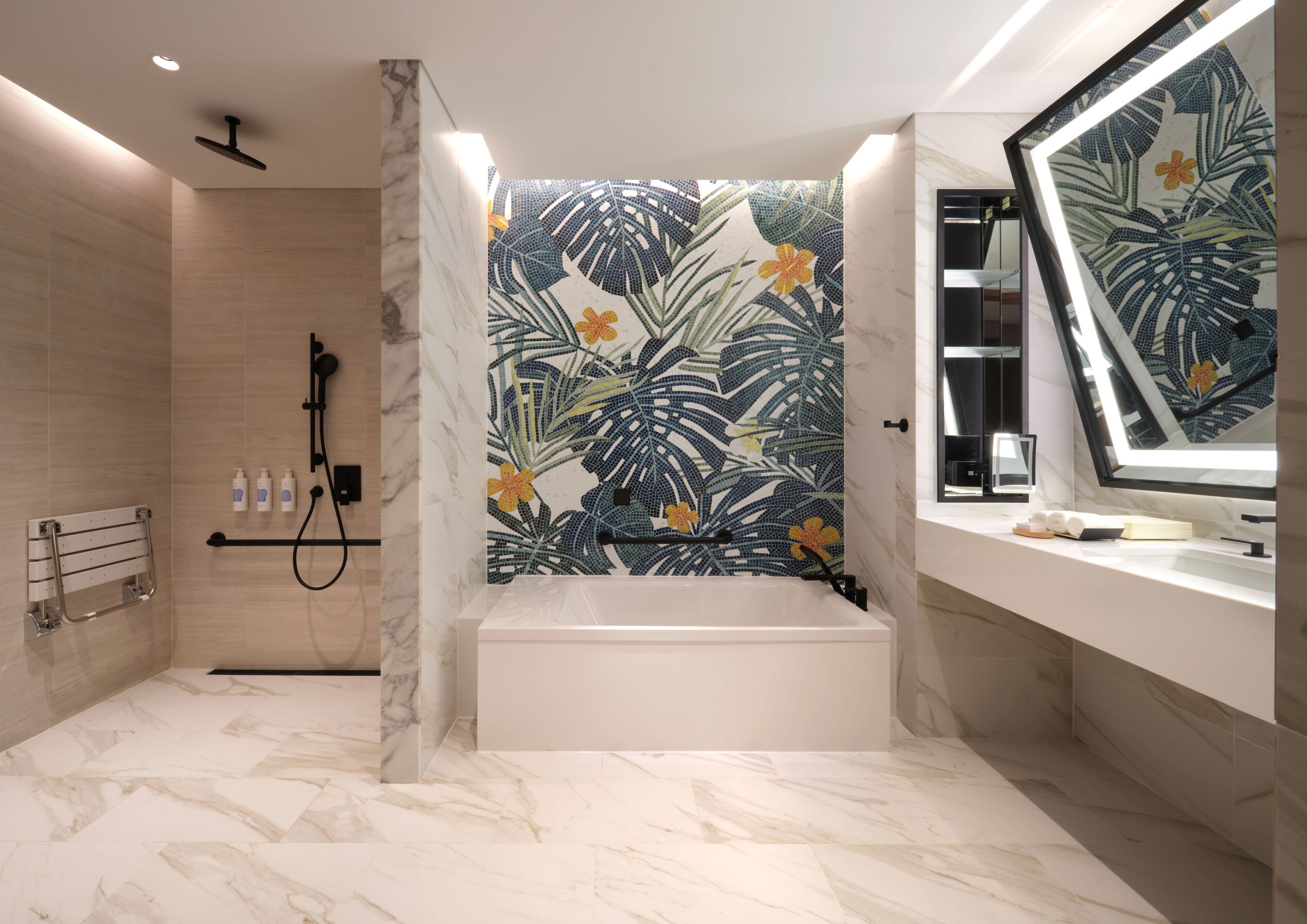 A modern bathroom with a bathtub, a shower, and a vanity with a mirror.