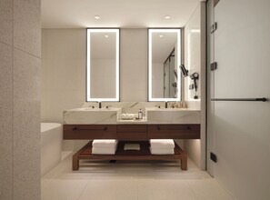 A modern bathroom with two sinks, a large mirror, and a bench with towels. - Inspire Entertainment Resort (Incheon)