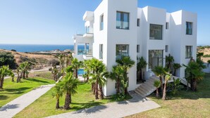 A modern white building with multiple floors, large windows, and a view of the sea. - Le Tanger By Mnar Palm (Al Bahraoyine)