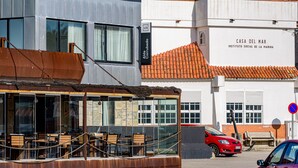 A building with a sign for 'Casa del Mar' and a red car parked in front. - Alda Corrubedo (Ribeira)