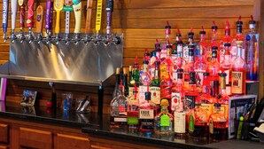 A bar area with multiple beer taps and a variety of liquor bottles. - Hope Hotel & Conference Center (Dayton)