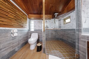 A modern bathroom with a wooden ceiling, a toilet, a shower enclosure, and a marble-tiled wall. - Calisto Valley I Luxury Pool Villa Krabi (Krabi)