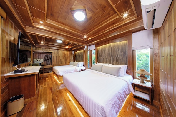 A wooden cabin with two beds, a TV, and a window with a view of greenery. - Calisto Valley I Luxury Pool Villa Krabi (Krabi)