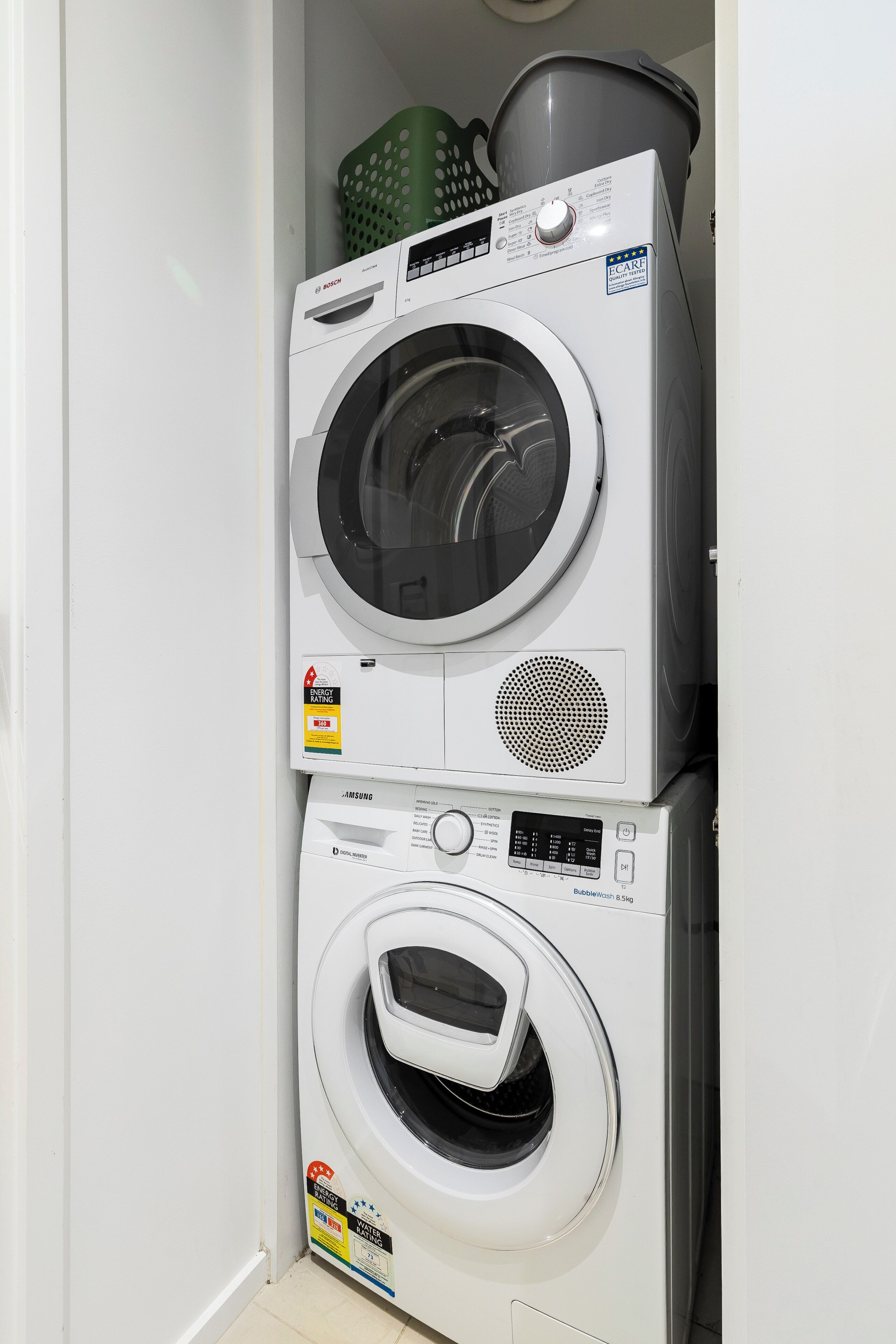 A stacked washer and dryer unit in a laundry room.