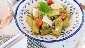 A bowl of pasta with cherry tomatoes and cheese garnished with a basil leaf. - ibis budget Montauban Les Chaumes (Montauban)