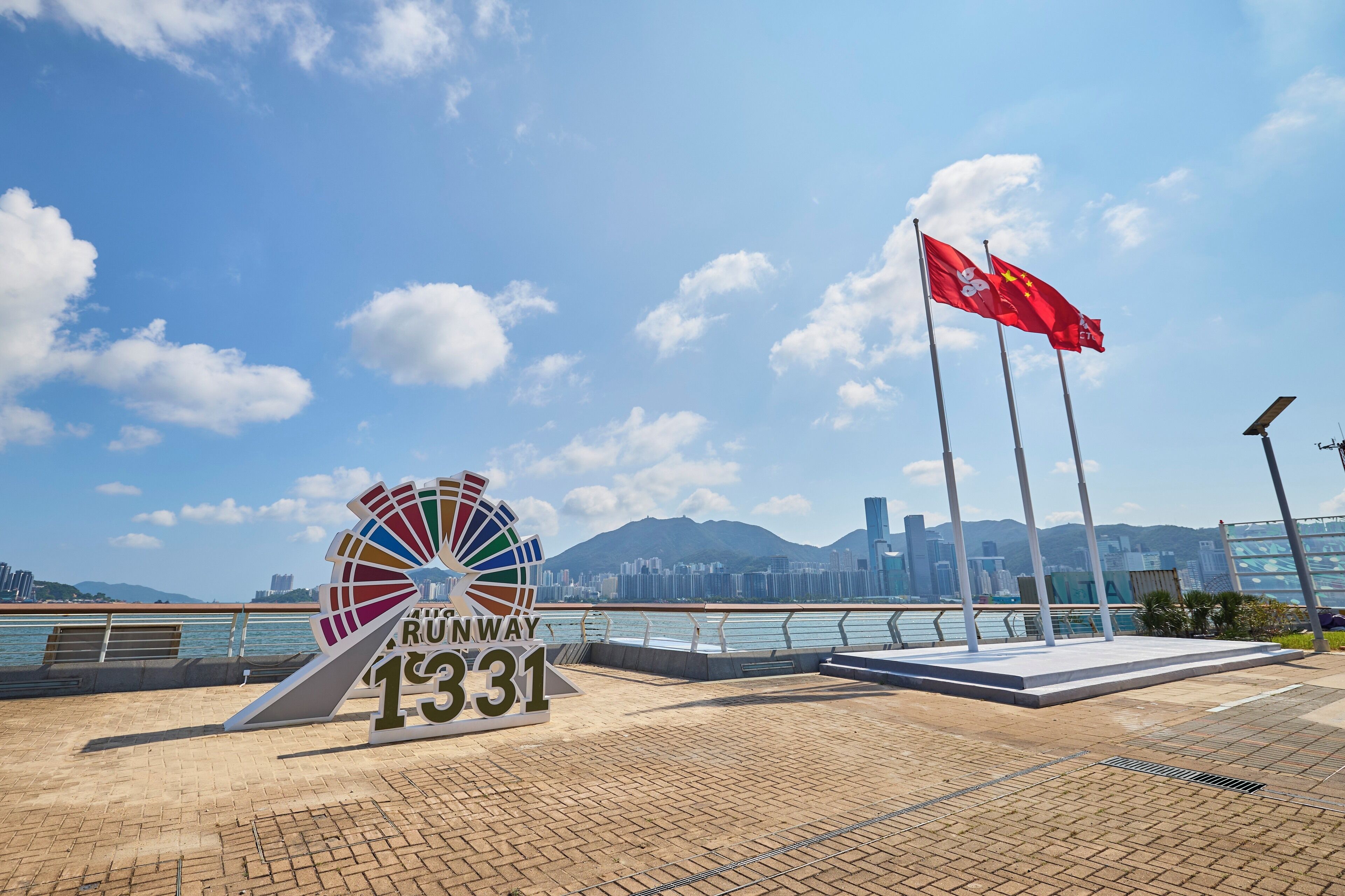 A paved walkway with a sign reading "RUSNWAY 1331" and a flagpole with a flag.