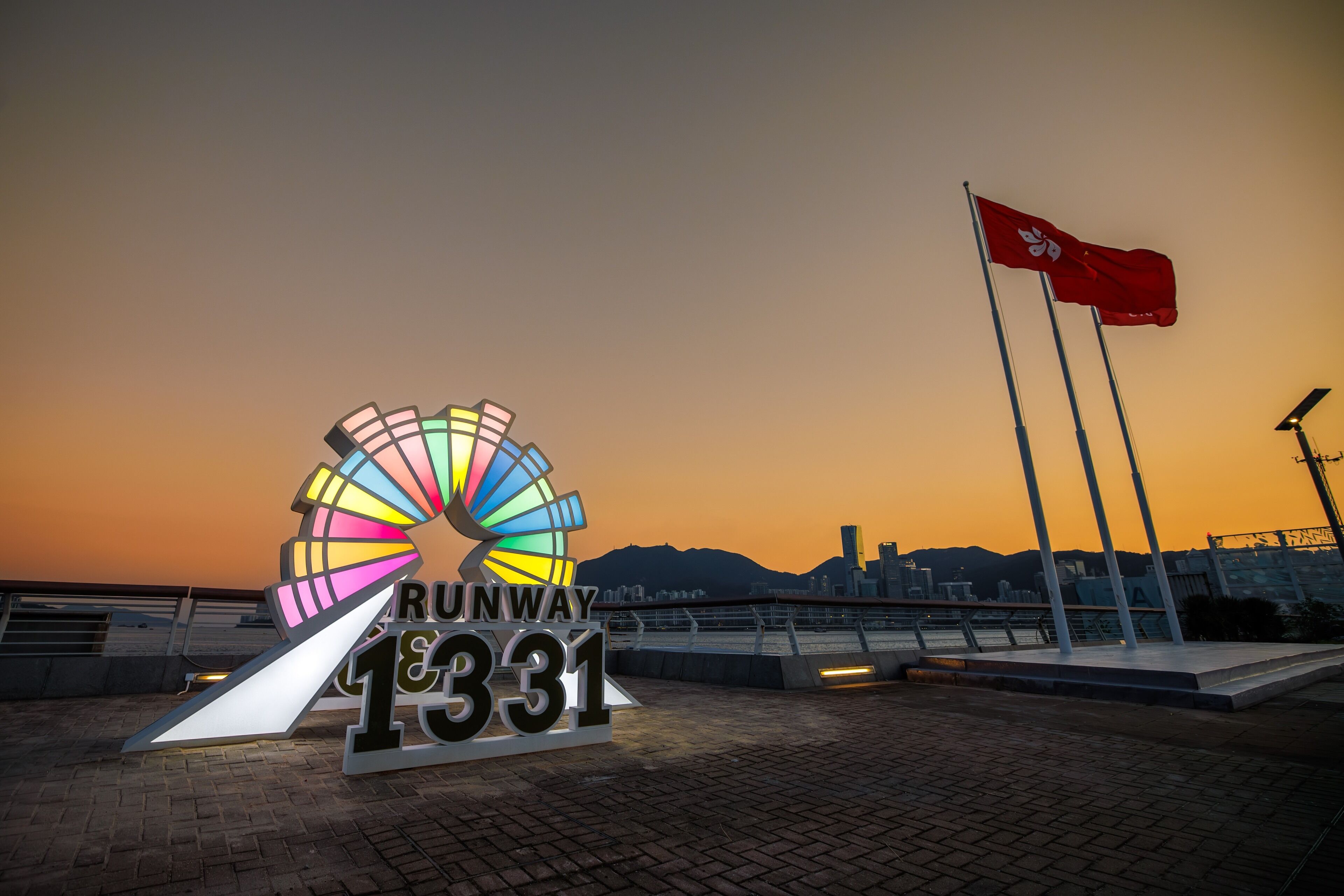 A sign with "RUNWAY 1331" and a colorful wheel structure.