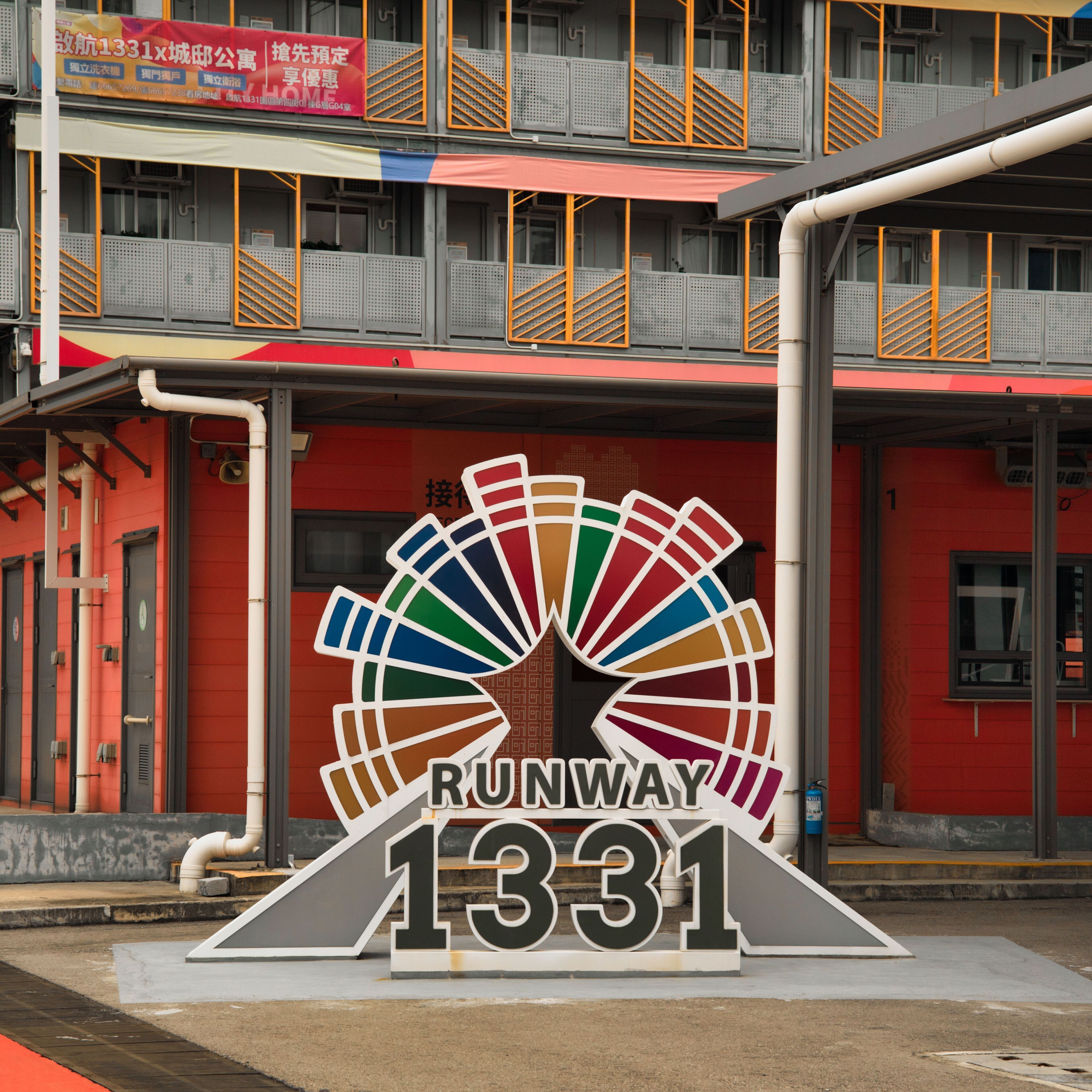 A building with a large sign reading 'RUNWAY 1331' and a colorful fan-like design above the number.