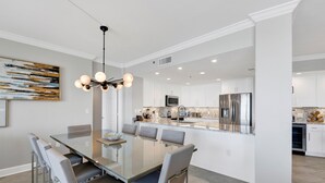 A modern kitchen with white cabinets, stainless steel appliances, and a marble countertop. - Beach Club B1805 Pools-54-ft balcony K/K/K/K/Bonus room with Q & Tw-XL Sleeps 11 (Gulf Shores)