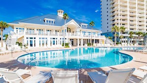 A resort with a large pool, white lounge chairs, and a multi-story building with balconies. - Beach Club B1805 Pools-54-ft balcony K/K/K/K/Bonus room with Q & Tw-XL Sleeps 11 (Gulf Shores)