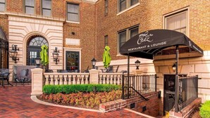 A brick building with a restaurant and lounge sign.