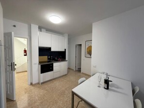 Fridge, toaster, cookware/dishes/utensils, dining tables
