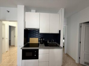 Fridge, toaster, cookware/dishes/utensils, dining tables