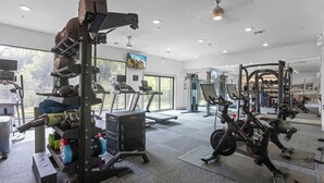 A gym with cardio equipment, weight machines, and a treadmill. - Charming 2-bedroom apartment with Pool, Gym. Close to Dwtn & Airport (Austin)