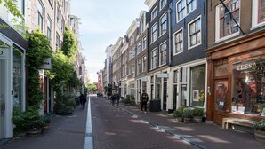 A narrow street lined with traditional buildings, some with shops on the ground floor. - Twenty Five Garden (Room 2) (Amsterdam)
