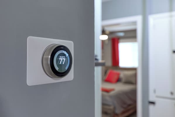 A thermostat on a wall displaying a temperature of 77°F. - The Southern Charm 4.0. 10 minutes away from Fort Moore/Benning.Budget friendly! (Columbus)