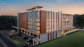 A modern hotel with a prominent 'FORTUNE' sign, multiple floors, and a well-maintained lawn. - Fortune Select Siliguri - Member ITC Hotels' Group (Jalpaiguri)