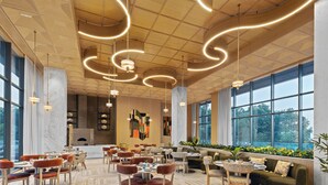 A spacious dining area with multiple tables and chairs, large windows, and a modern ceiling design. - Fortune Select Siliguri - Member ITC Hotels' Group (Jalpaiguri)