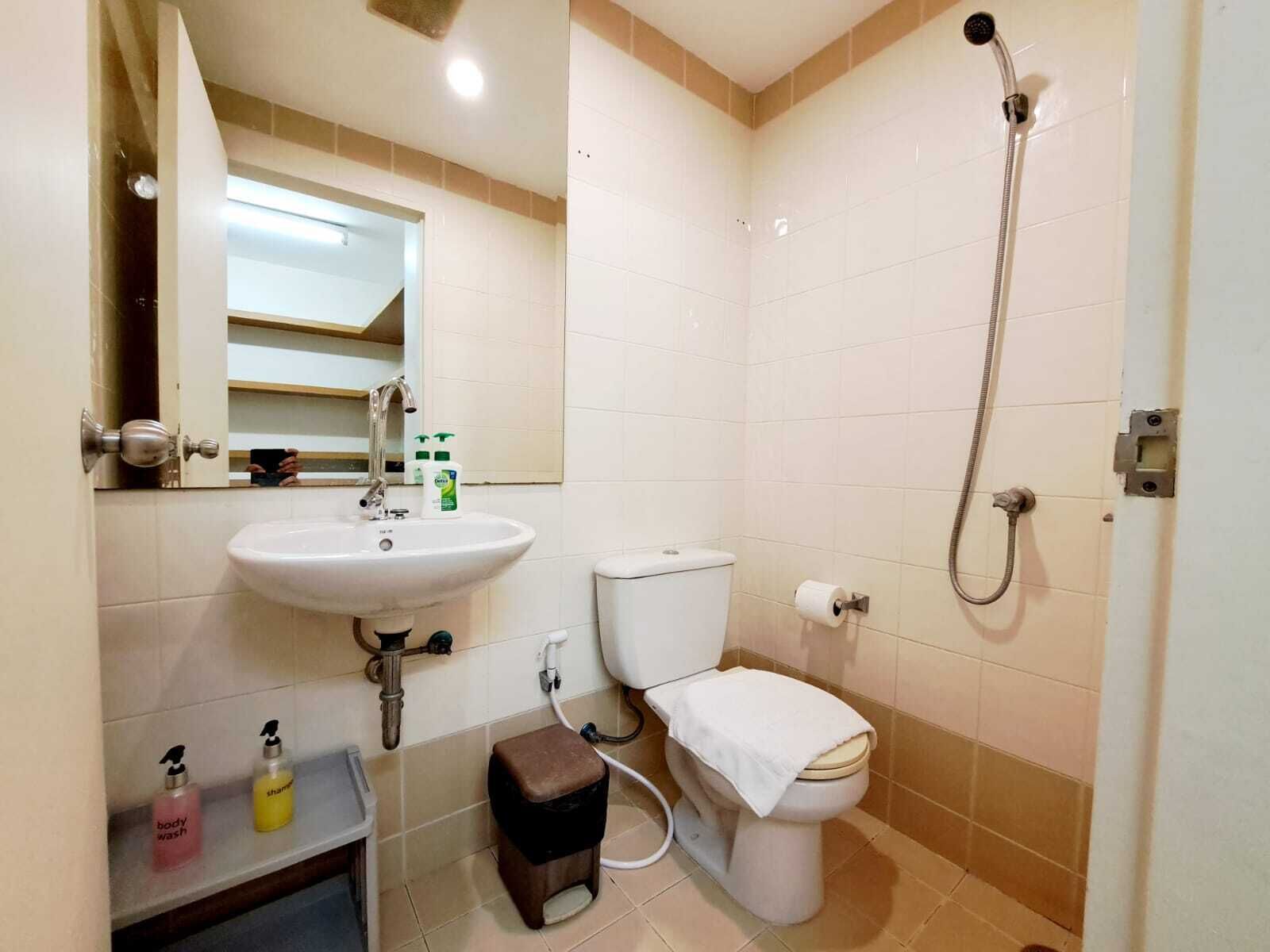A bathroom with a sink, toilet, and shower.
