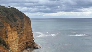 A coastal landscape with a cliff and beach. - Idyllic Aireys Retreat - where ocean & hills meet (Aireys Inlet)
