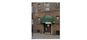 A brick building with a green awning labeled 'Royal Court' at 325 34th St.