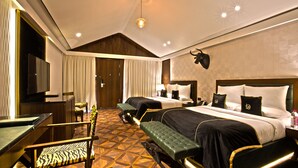 Een hotelkamer met twee bedden, een televisie, een bureau en een stoel met een zebraprint.