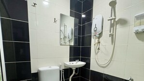 A bathroom with a toilet, sink, and shower. - Gemilang Star Hotel (Port Dickson)