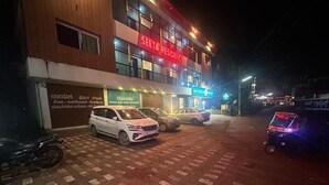 A multi-story building with a sign reading "SEETA RESIDENCY." There are several parked cars and a motorcycle in front. - Seeta Residency (Gokarna)