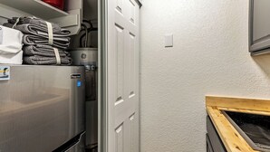 A compact kitchen with a stainless steel refrigerator, a wooden countertop, and a white textured wall. - Cozy stay for 2: 5 Min Drive to Base,  Full Kitchen, Shared Hot Tub & Pool, Restaurants Nearby! (Park City)