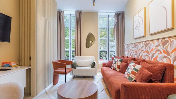 A modern living room with a sofa, armchair, and coffee table.
