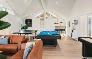 A spacious living area with a pool table, a sofa, and a dartboard. - Lovely home in Idestrup with sauna (Idestrup)