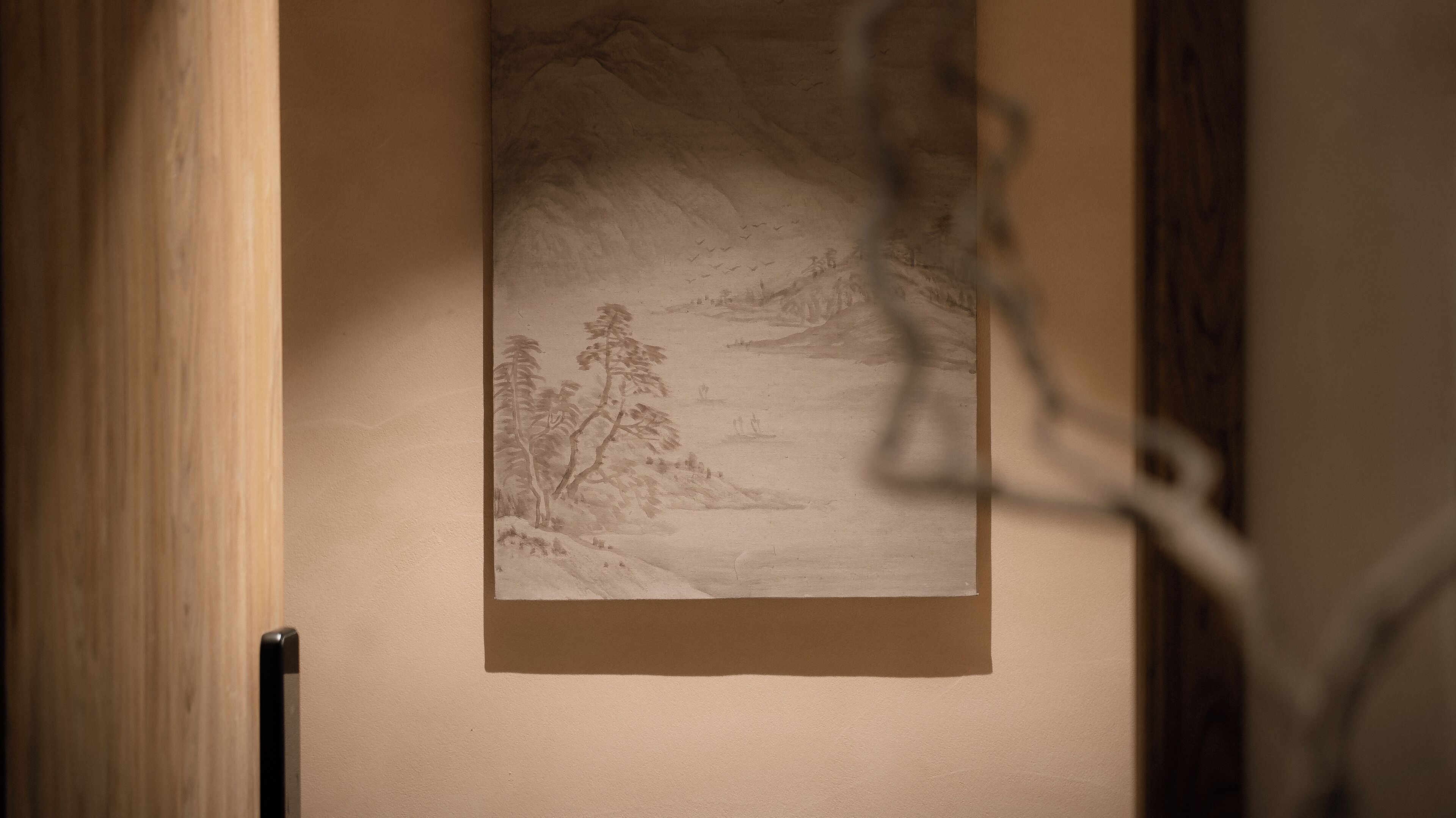 A framed artwork on a wall.