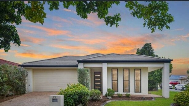 A single-story house with a garage, a covered porch, and a well-maintained lawn. - Beautiful 4 BDR House with ensuite and A/C (Redbank Plains)