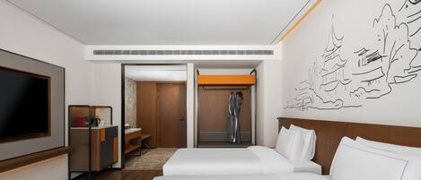 A hotel room with a large bed, a TV, a desk, and a bathroom with a shower.