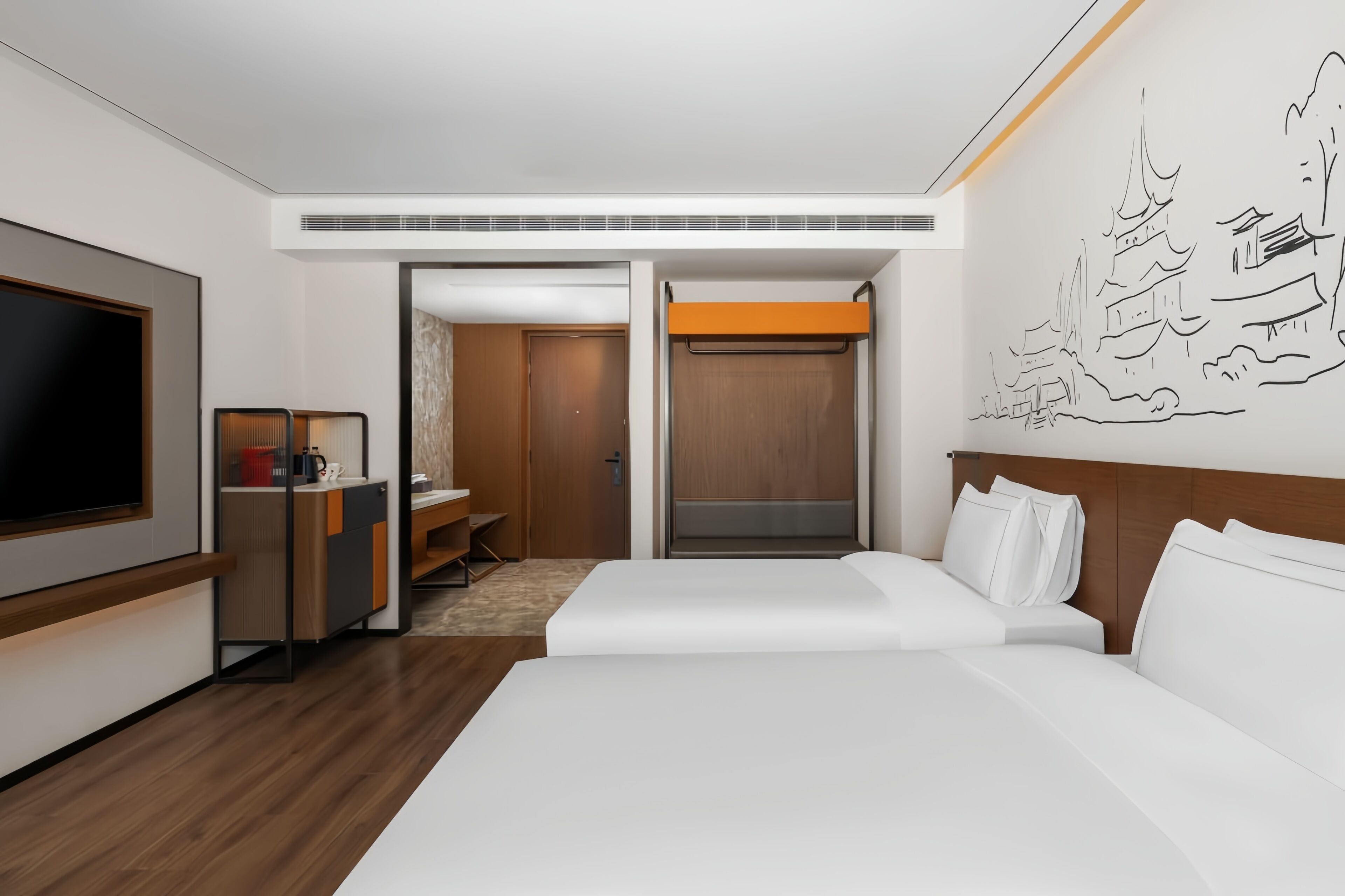 A modern hotel room with a large bed, a TV, a desk, and a wardrobe.