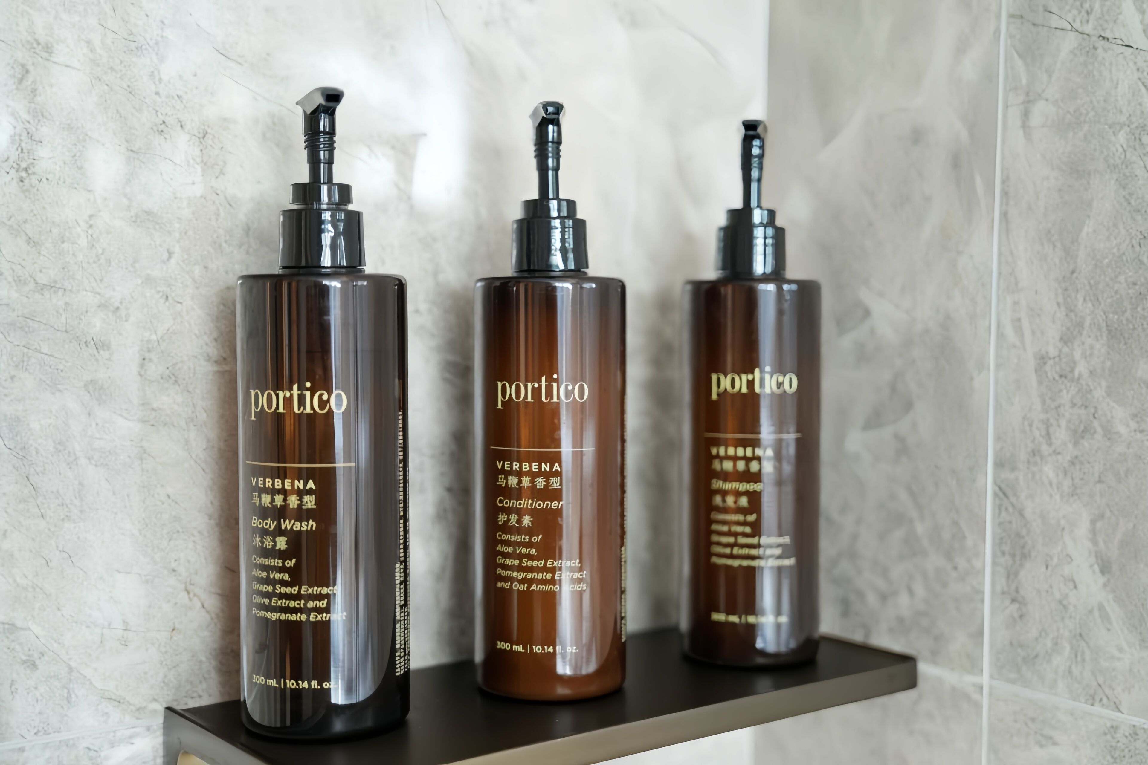 Tres productos de cuidado corporal Portico en una estantería.