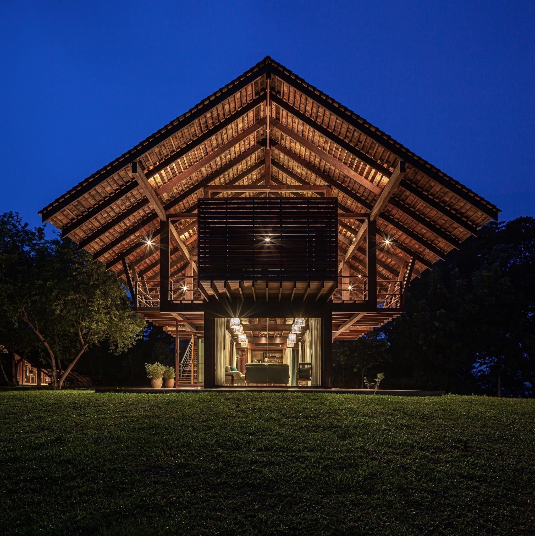 A modern building with a wooden exterior and a large open entrance area.