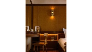 A compact hotel room with a bed, a desk, a chair, and a bedside table. - Confidential Room 4, a Stone's Throw From the Louvre (Paris)