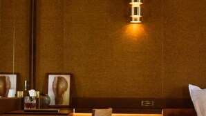 A compact hotel room with a bed, a desk, a chair, and a bedside table. - Confidential Room 4, a Stone's Throw From the Louvre (Paris)