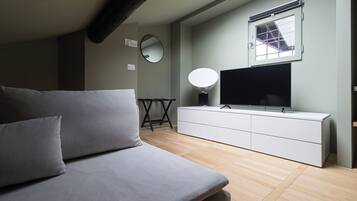 Apartment (1 Bedroom) | Living area | 32-inch Smart TV with cable channels