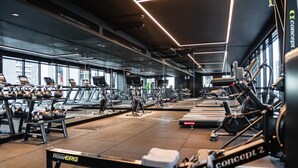 A gym with various exercise equipment, including treadmills, stationary bikes, and weight machines. - Stylish Southbank 1-bedroom With Pool and Gym (Melbourne)