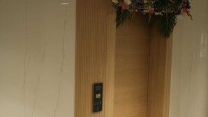 Un ascenseur en bois avec une plaque portant le numéro 309.