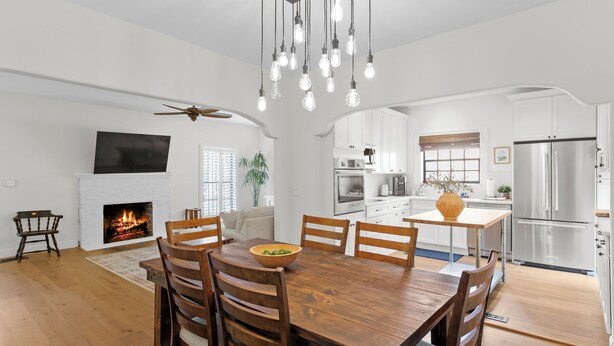 A modern kitchen with white cabinets, a large island, and a built-in oven. - Original Davis Islands Spanish Mission Bungalow (Tampa)